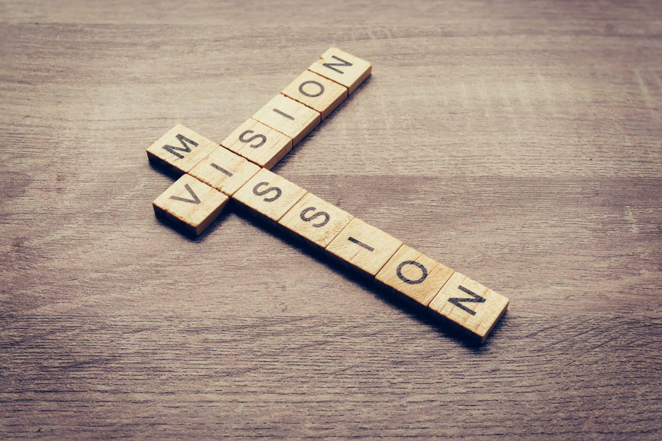 Vision and Mission word on wood table for business concept.